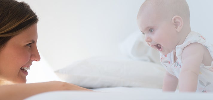 Mum and baby looking at each other during tummy time
