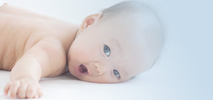 Baby doing tummy time after a nappy change