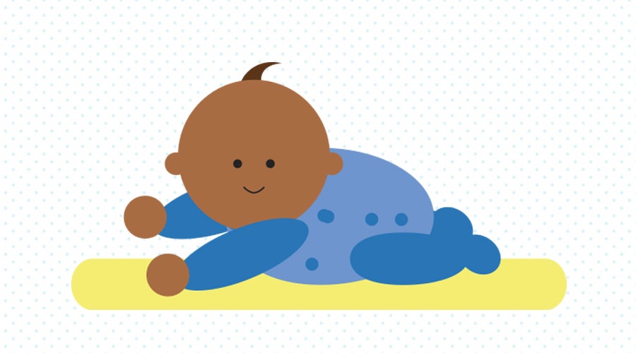 Baby playing on a soft surface like they are swimming