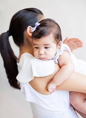 Mum burping baby on her shoulder
