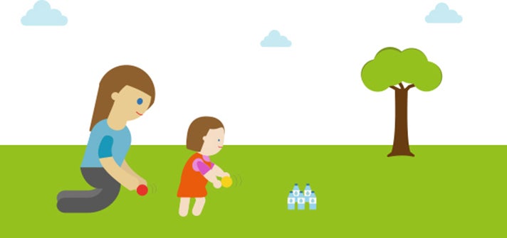 Mum and toddler bowling with water bottles and a round ball