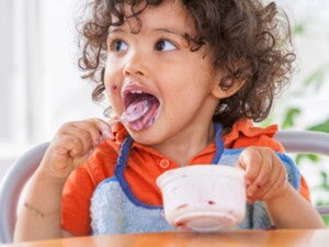 toddler eating yoghurt toddler eating yoghurt