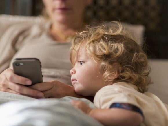 young child looking at mothers phone young child looking at mothers phone