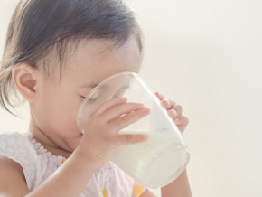 Child drinking milk from cup Child drinking milk from cup