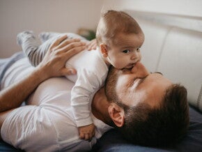 Baby lying on their dad's tummy Baby lying on their dad's tummy