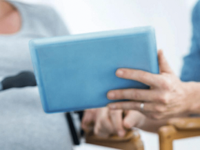 Pregnant woman being shown an ipad by medical professional