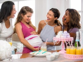 four woman playing a baby shower game four woman playing a baby shower game
