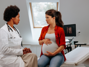pregnant lady talking to a doctor pregnant lady talking to a doctor