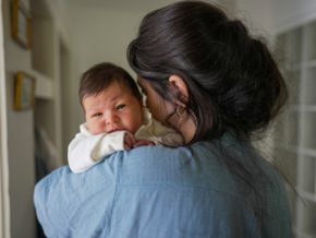 Mother holding upset baby Mother holding upset baby