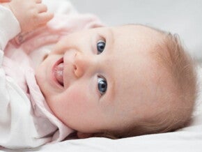 Baby lying down on bed with cradle cap on head Baby lying down on bed with cradle cap on head