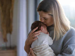 Mother kissing babies head