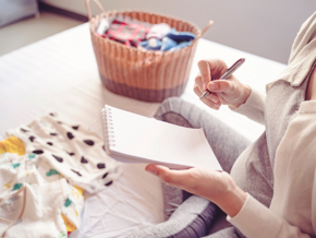 Pregnant woman writing on a notepad Pregnant woman writing on a notepad