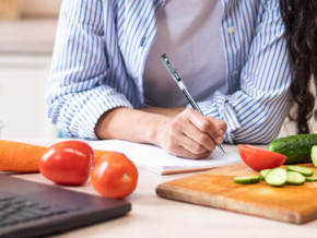 writing down a menu in the kitchen with food around writing down a menu in the kitchen with food around