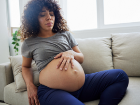 Pregnant lady holding stomach in pain Pregnant lady holding stomach in pain
