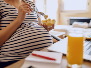 Pregnant woman eating banana Pregnant woman eating banana