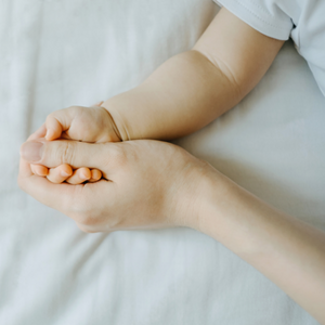 Parent Holding Babies Hand