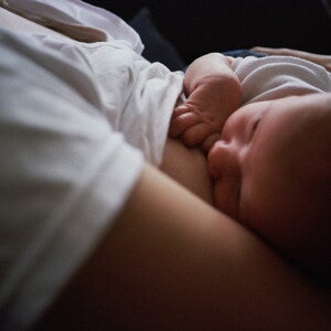 Mother breastfeeding baby in dark