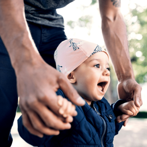 Toddler walking with their dad