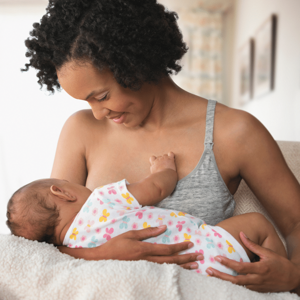 Mother breastfeeding her baby while smiling Mother breastfeeding her baby while smiling