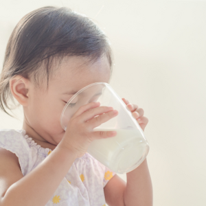Child drinking milk from cup