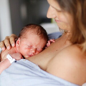 Mother doing skin-to-skin kangaroo care bonding with baby