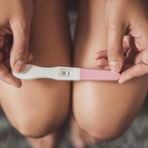 Woman holding pregnancy test