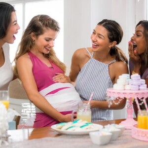  four woman playing a baby shower game