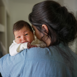 Mother holding upset baby