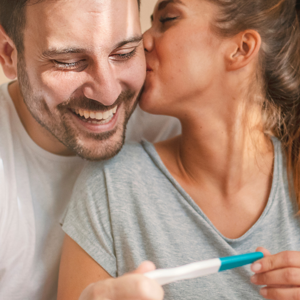 couple holding a pregnancy test couple holding a pregnancy test