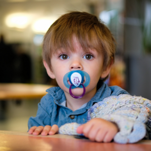 Toddler boy with dummy in his mouth