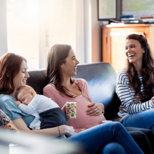 women laughing pregnant and baby