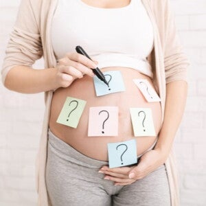 pregnant woman's belly with question marks pregnant woman's belly with question marks