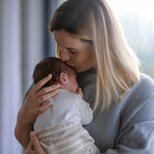 Mother kissing babies head