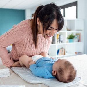 Mother changing her babies nappy