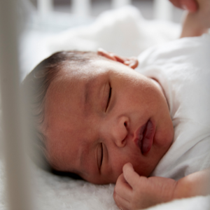 newborn baby asleep in cot newborn baby asleep in cot