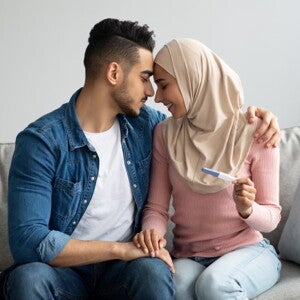 man and woman looking intimate holding pregnancy test man and woman looking intimate holding pregnancy test