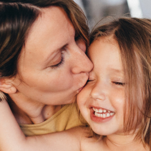 Mother kissing her daughter Mother kissing her daughter