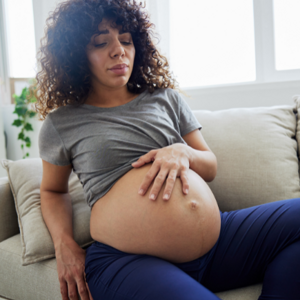 Pregnant lady holding stomach in pain