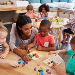 Teacher and children sitting around a table