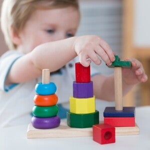 toddler playing with wooden blocks toddler playing with wooden blocks