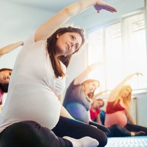 Pregnant woman in a prenatal yoga class with other pregnant mums-to-be