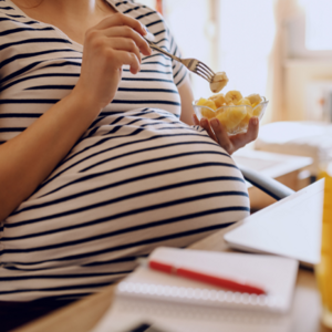 Pregnant woman eating banana
