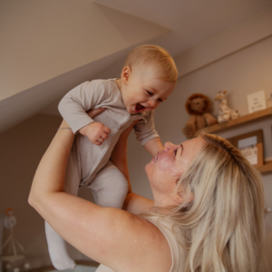 Mother holding baby in the air 