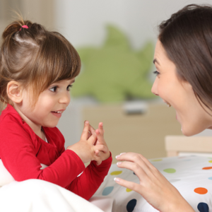 Toddler girl talking to her mother
