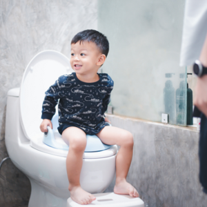Toddler boy sitting on the toilet