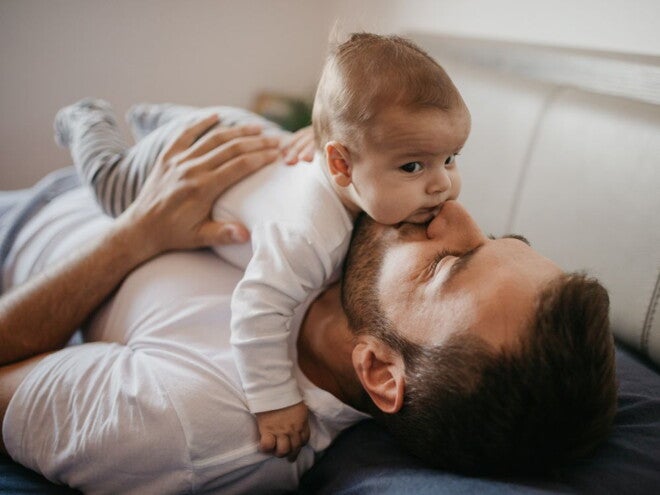Baby lying on their dad's tummy Baby lying on their dad's tummy