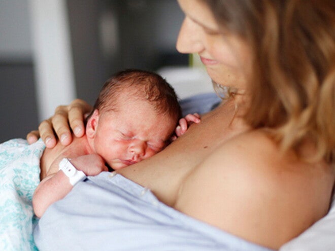 Mother doing skin-to-skin kangaroo care bonding with baby