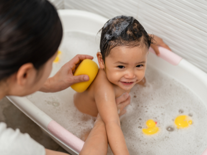 toddler enjoying bath time in a bathtub toddler enjoying bath time in a bathtub