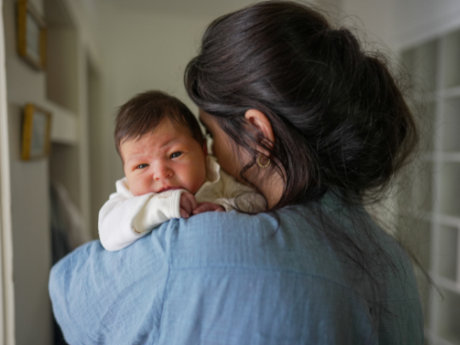 Mother holding upset baby Mother holding upset baby