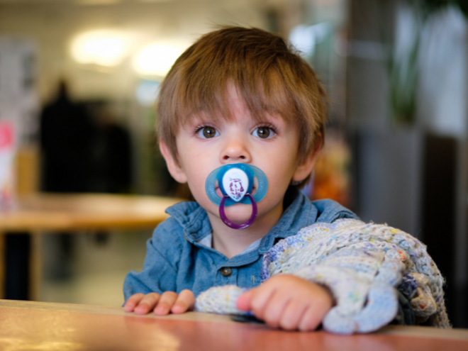 Toddler boy with dummy in his mouth Toddler boy with dummy in his mouth